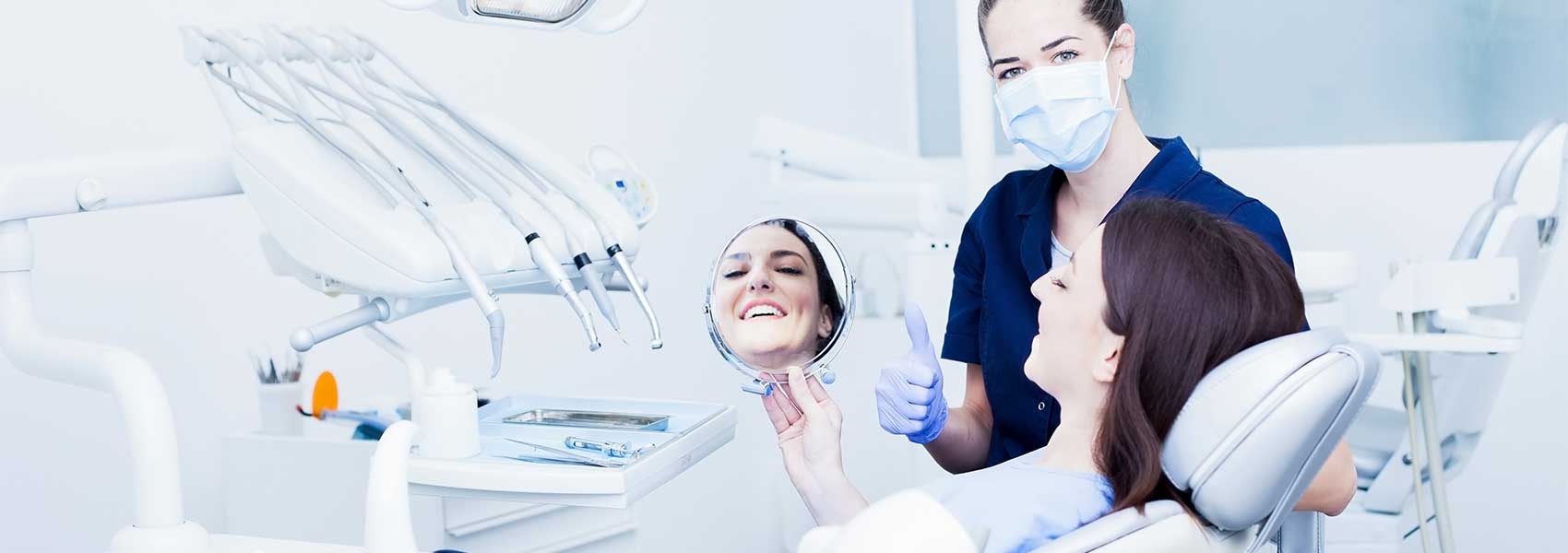 The patient looking at her teeth after treatments